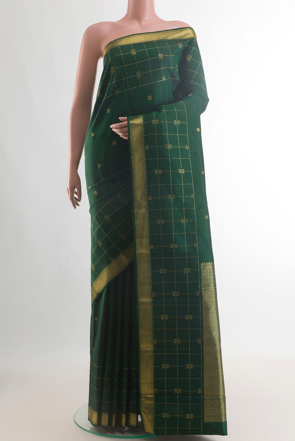 Pure Silk Green Kanjivaram Saree with Zari Butta on the body and Zari Border.  displayed on a mannequin