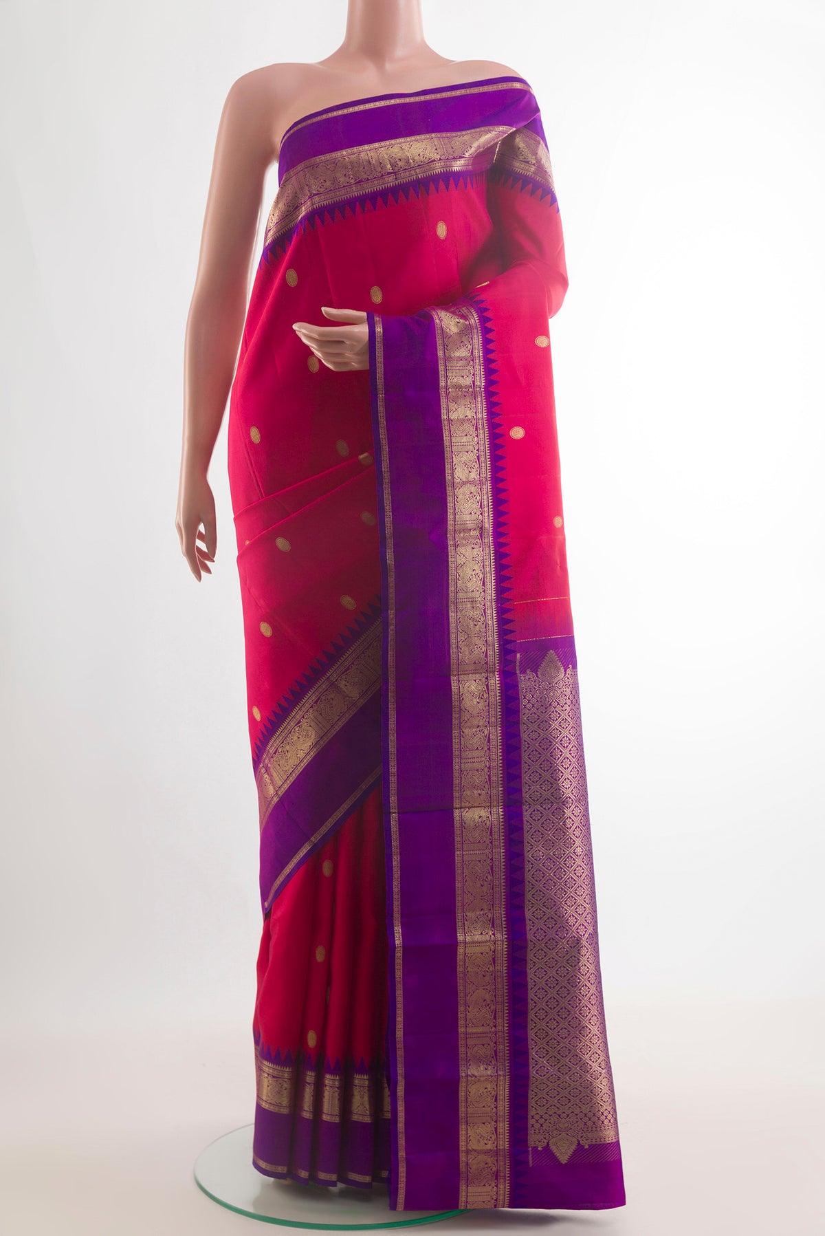 Pure Silk Red Kanjivaram Saree with Zari Butta on the body and Zari Border.  displayed on a mannequin