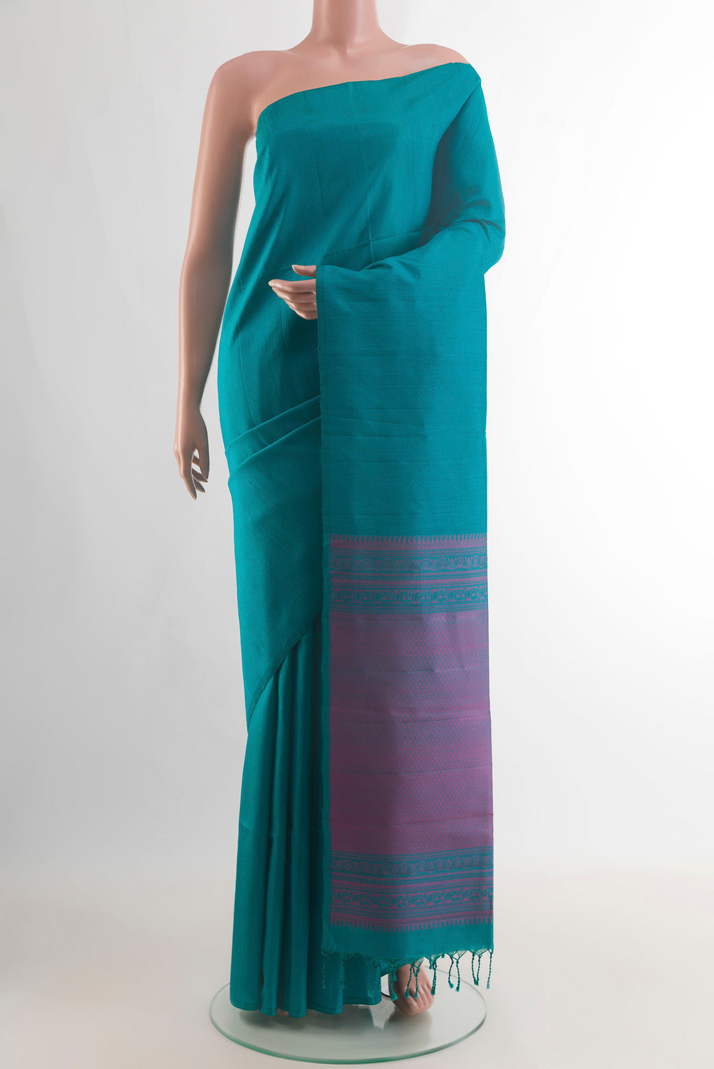 Pure Silk Sea Green Soft Saree with Plain Body and Without Border.  displayed on a mannequin
