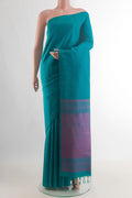 Pure Silk Sea Green Soft Saree with Plain Body and Without Border.  displayed on a mannequin