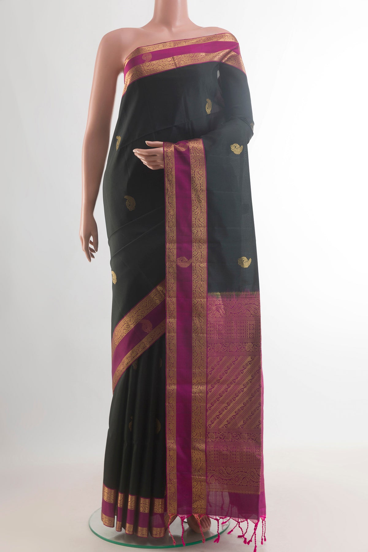 Pure Silk Black Soft Saree with Zari Butta on the body and Zari Border.  displayed on a mannequin