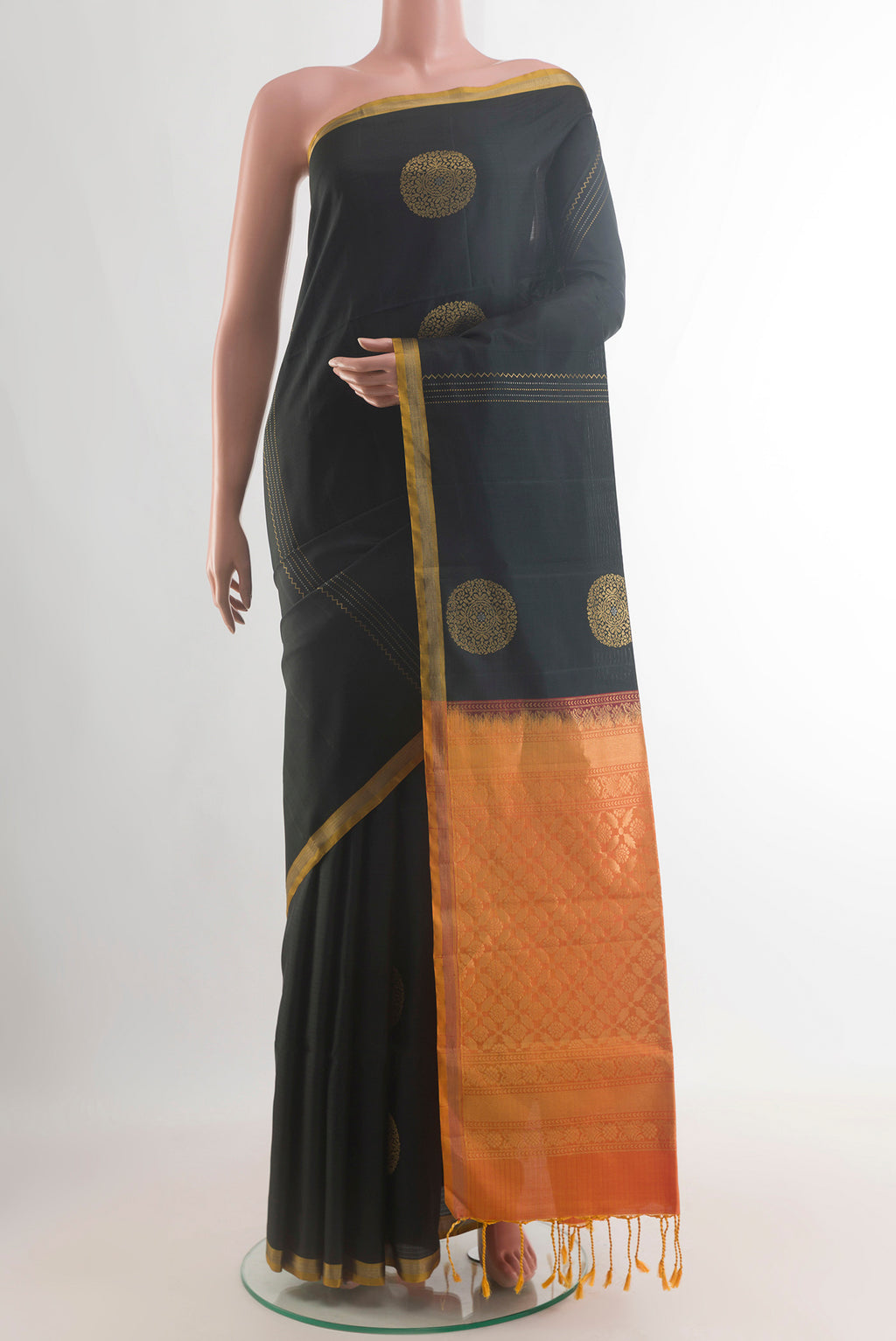 Pure Silk Black Soft Saree with Zari Butta on the body and Zari Border.  displayed on a mannequin