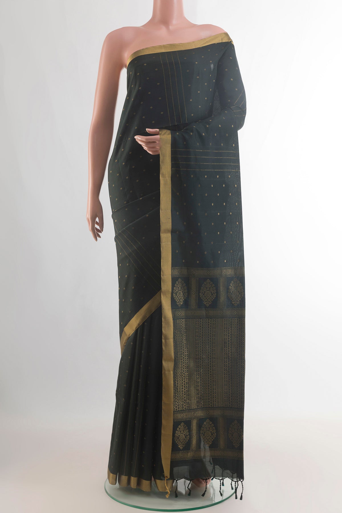 Pure Silk Black Soft Saree with Zari Butta on the body and Zari Border.  displayed on a mannequin