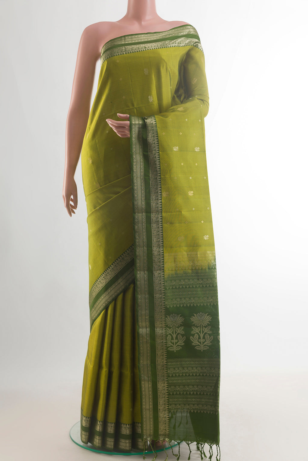 Pure Silk Green Soft Saree with Zari Butta on the body and Zari Border.  displayed on a mannequin