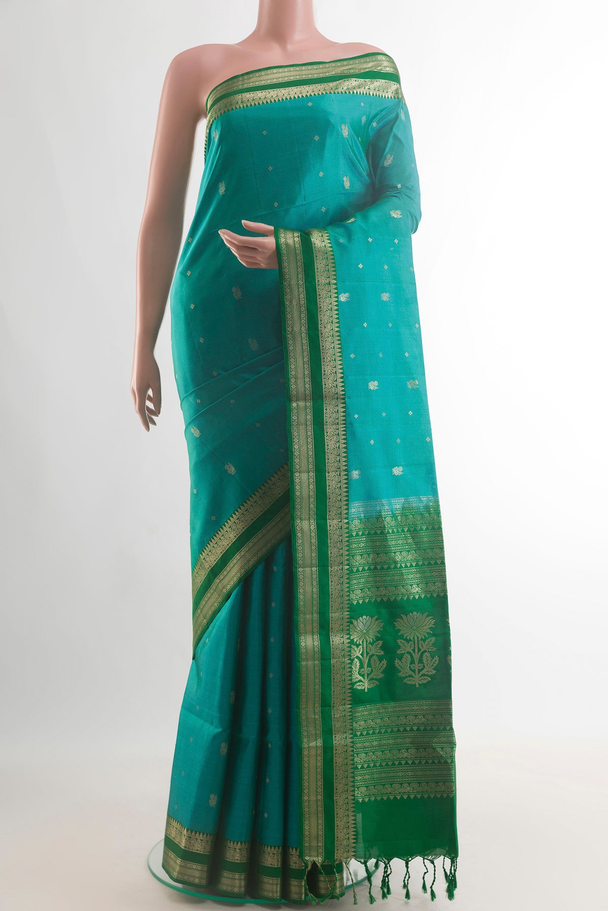Pure Silk Turquoise Soft Saree with Zari Butta on the body and Zari Border.  displayed on a mannequin