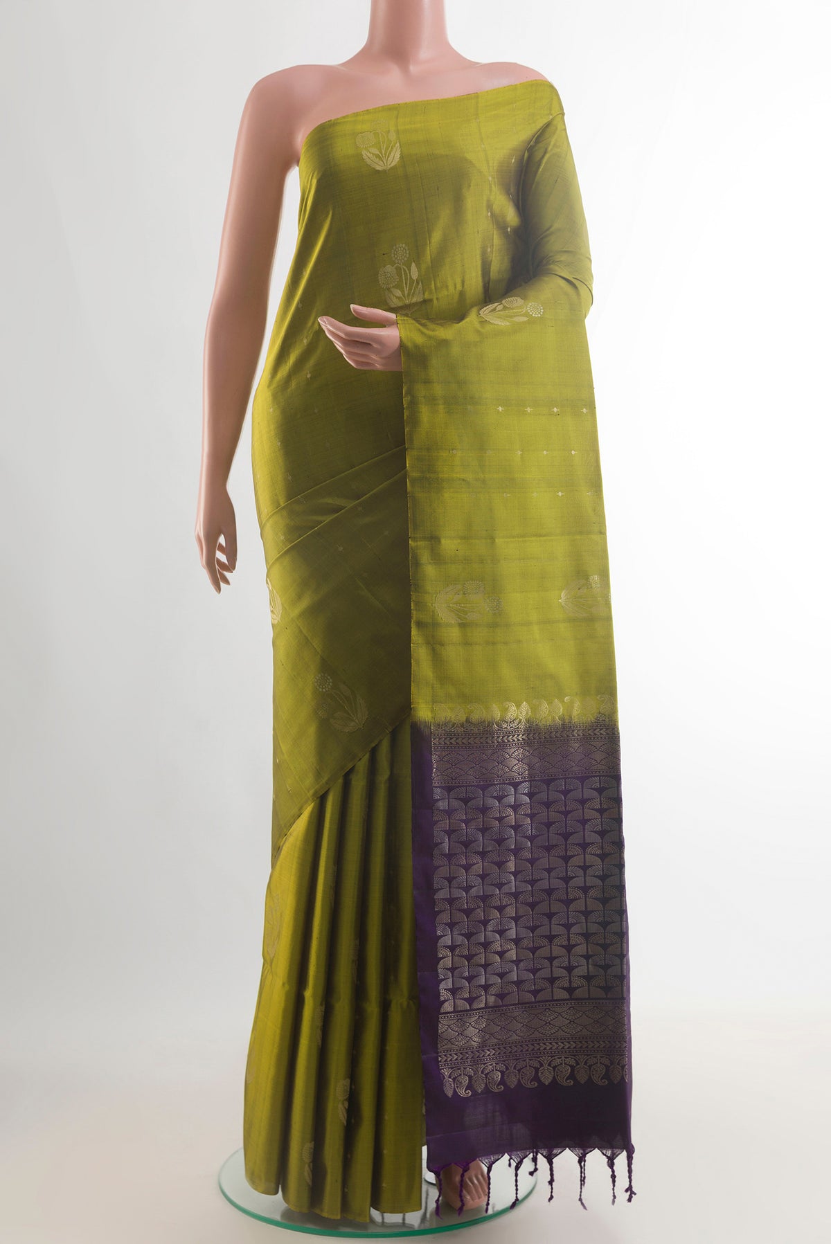 Pure Silk Mehandi Green Soft Saree with Zari Butta on the body and Without Border.  displayed on a mannequin