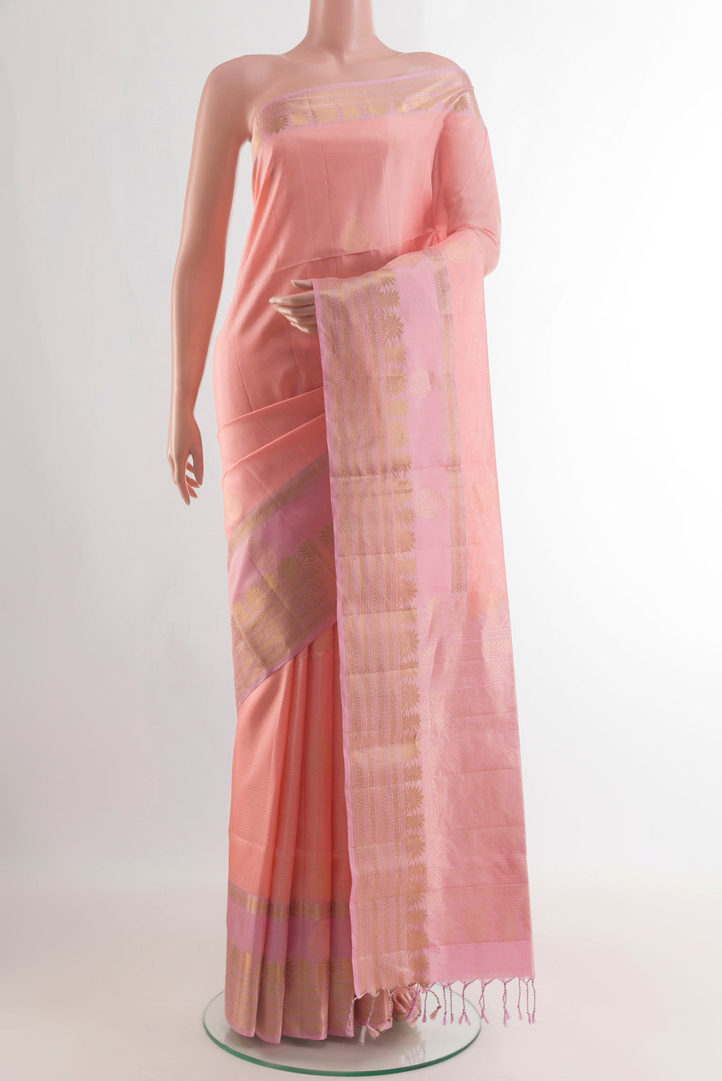 Pure Silk Peach Soft Saree with Zari Butta on the body and Zari Border.  displayed on a mannequin
