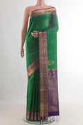 Pure Silk Green Soft Saree with Zari Butta on the body and Zari Border.  displayed on a mannequin