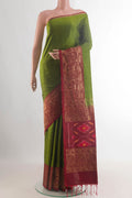 Pure Silk Green Soft Saree with Zari Butta on the body and Zari Border.  displayed on a mannequin