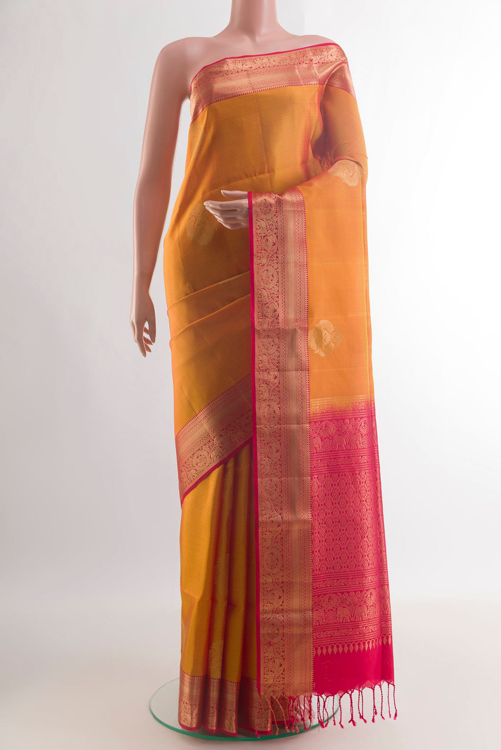 Pure Silk Yellow Kanjivaram Saree with Zari Butta on the body and Zari Border.  displayed on a mannequin