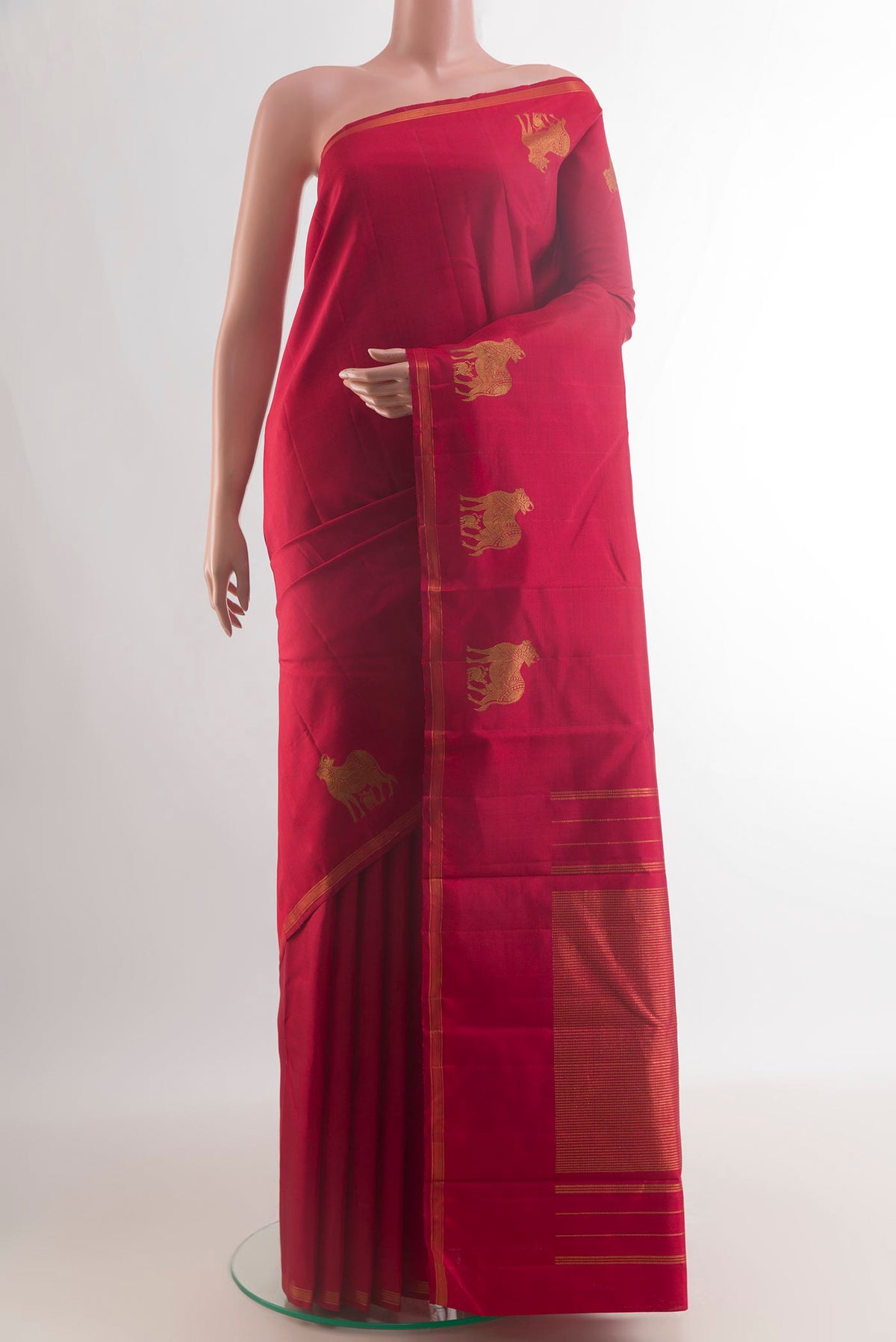 Pure Silk Red Kanchipuram Saree with Plain Body and Zari Border.  displayed on a mannequin
