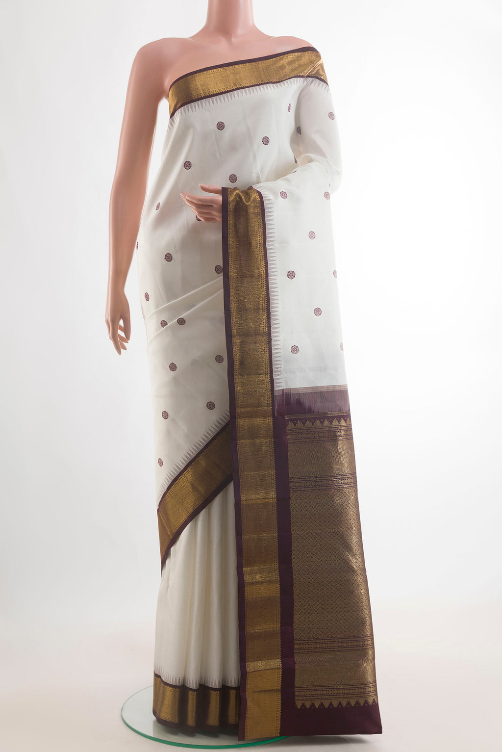 Pure Silk White Kanchipuram Saree with Thread Butta on the body and Zari Border.  displayed on a mannequin