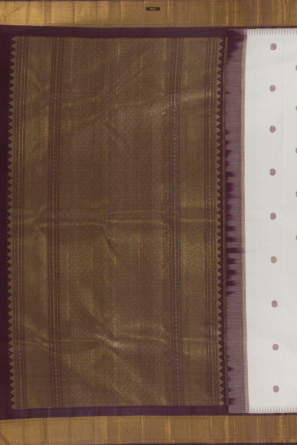 Close up image of the pallu of Pure Silk White Kanchipuram Saree with Thread Butta on the body and Zari Border. 