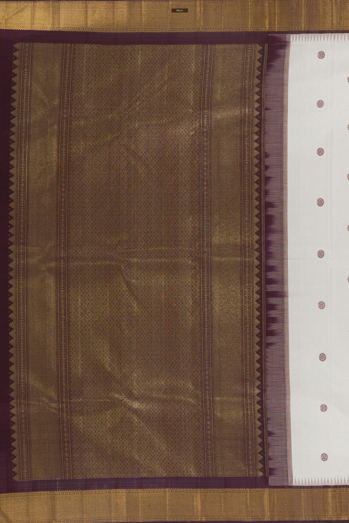 Close up image of the pallu of Pure Silk White Kanchipuram Saree with Thread Butta on the body and Zari Border. 