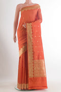 Pure Silk Orange Banarasi Katan Saree with Zari Butta on the body and Zari Border.  displayed on a mannequin