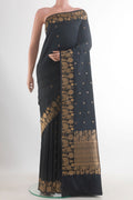 Pure Silk Black Banarasi Katan Saree with Zari Butta on the body and Zari Border.  displayed on a mannequin