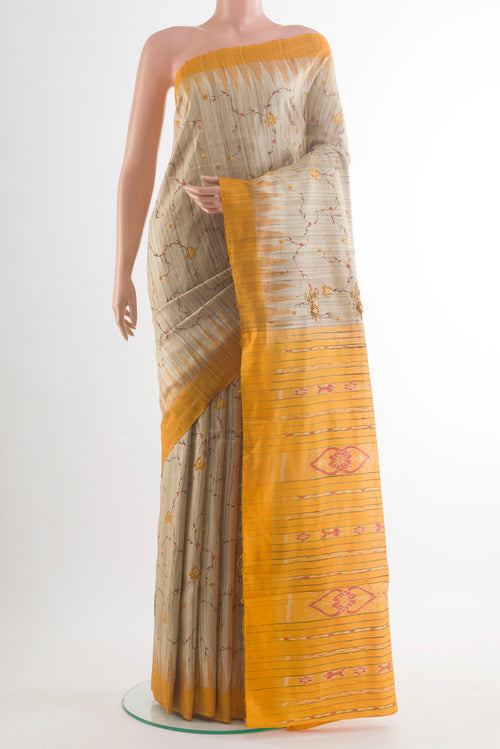 Beige Tussar Saree with Embroidery on the body and Temple Border.  displayed on a mannequin