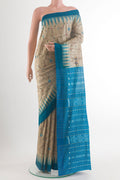 Beige Tussar Saree with Embroidery on the body and Temple Border.  displayed on a mannequin