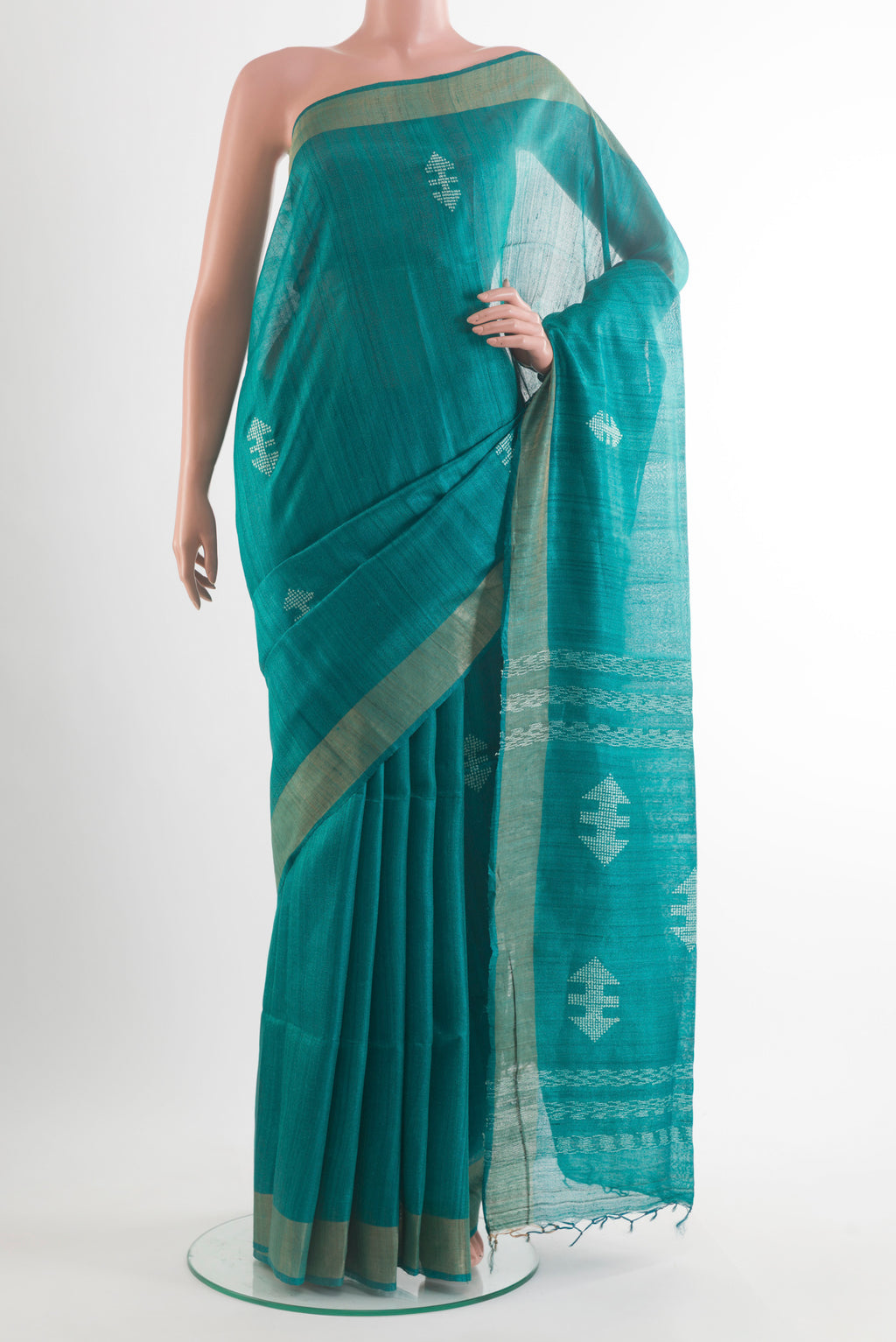Sea Green Tussar Saree with Thread Butta on the body and Zari Border.  displayed on a mannequin