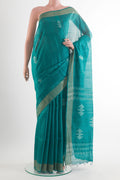Sea Green Tussar Saree with Thread Butta on the body and Zari Border.  displayed on a mannequin