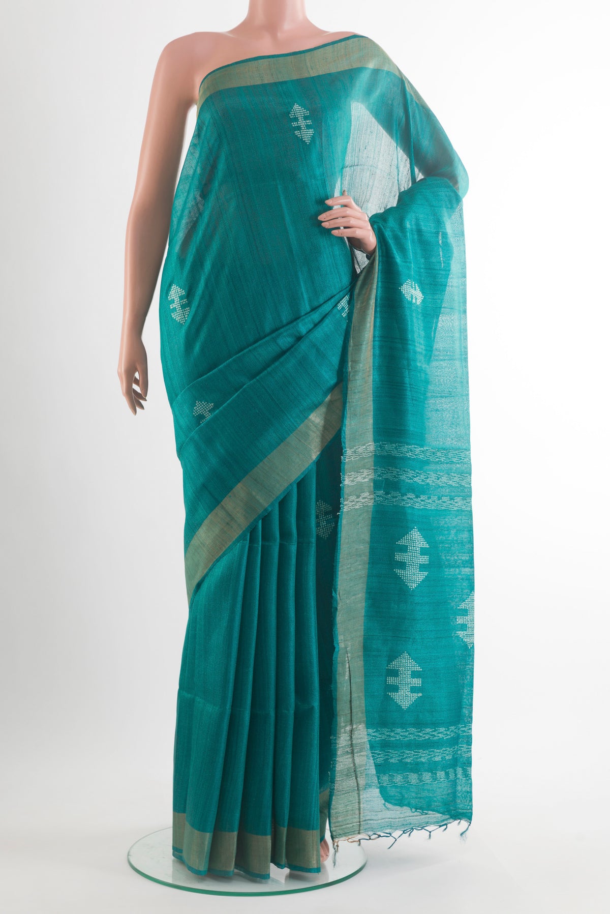 Sea Green Tussar Saree with Thread Butta on the body and Zari Border.  displayed on a mannequin
