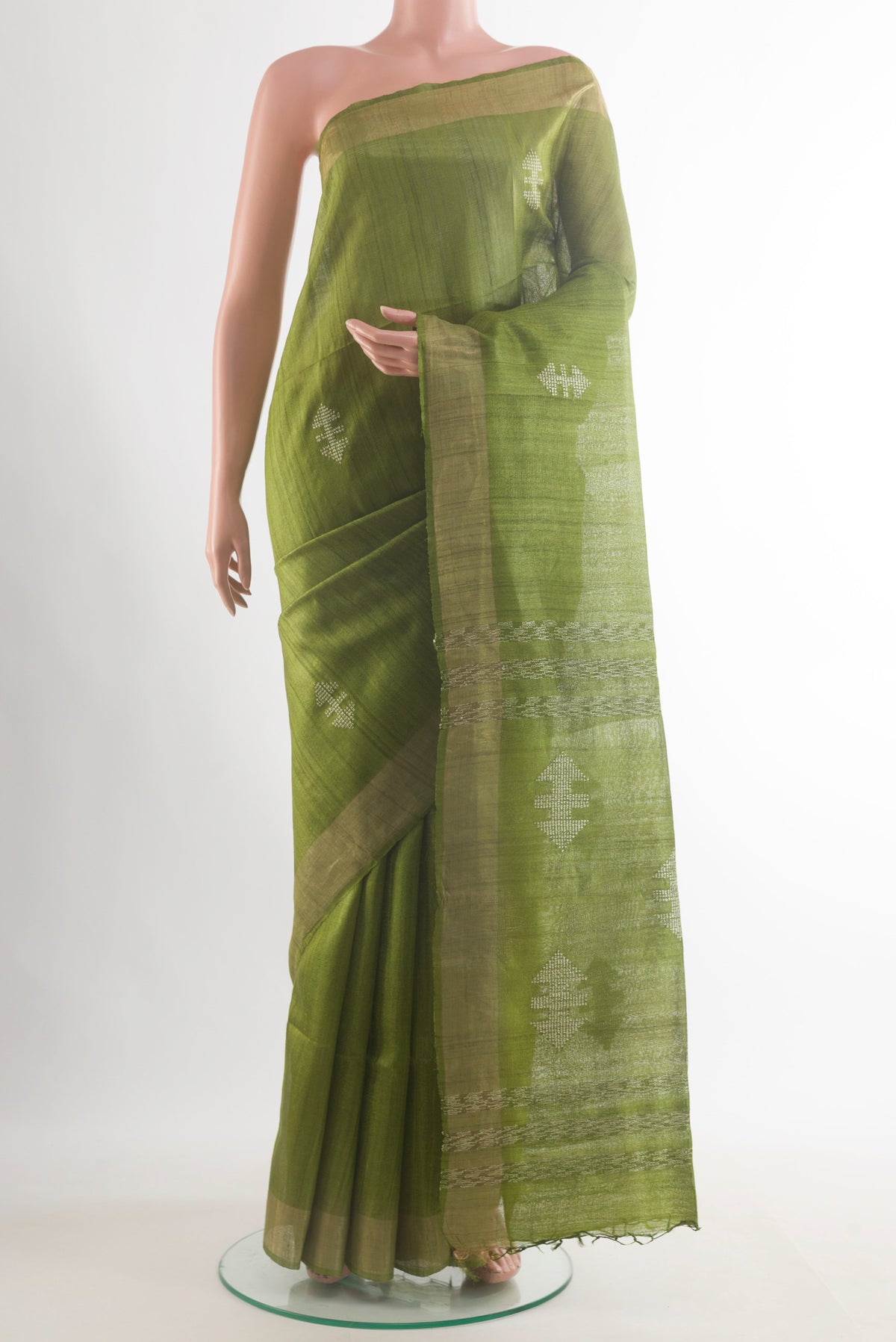 Green Tussar Saree with Embroidered on the body and Zari Border.  displayed on a mannequin