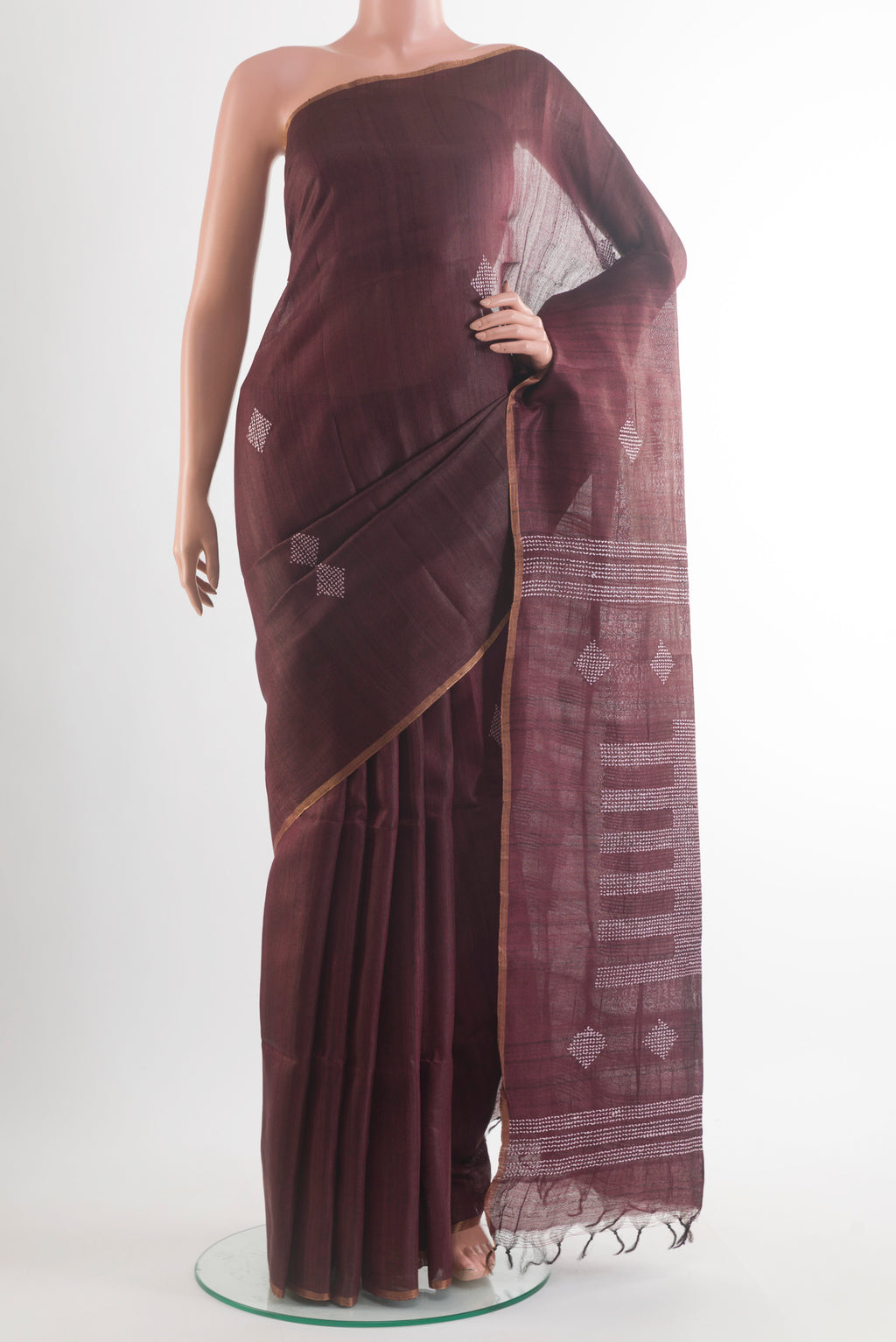 Brown Tussar Saree with Embroidery on the body and Zari Border.  displayed on a mannequin