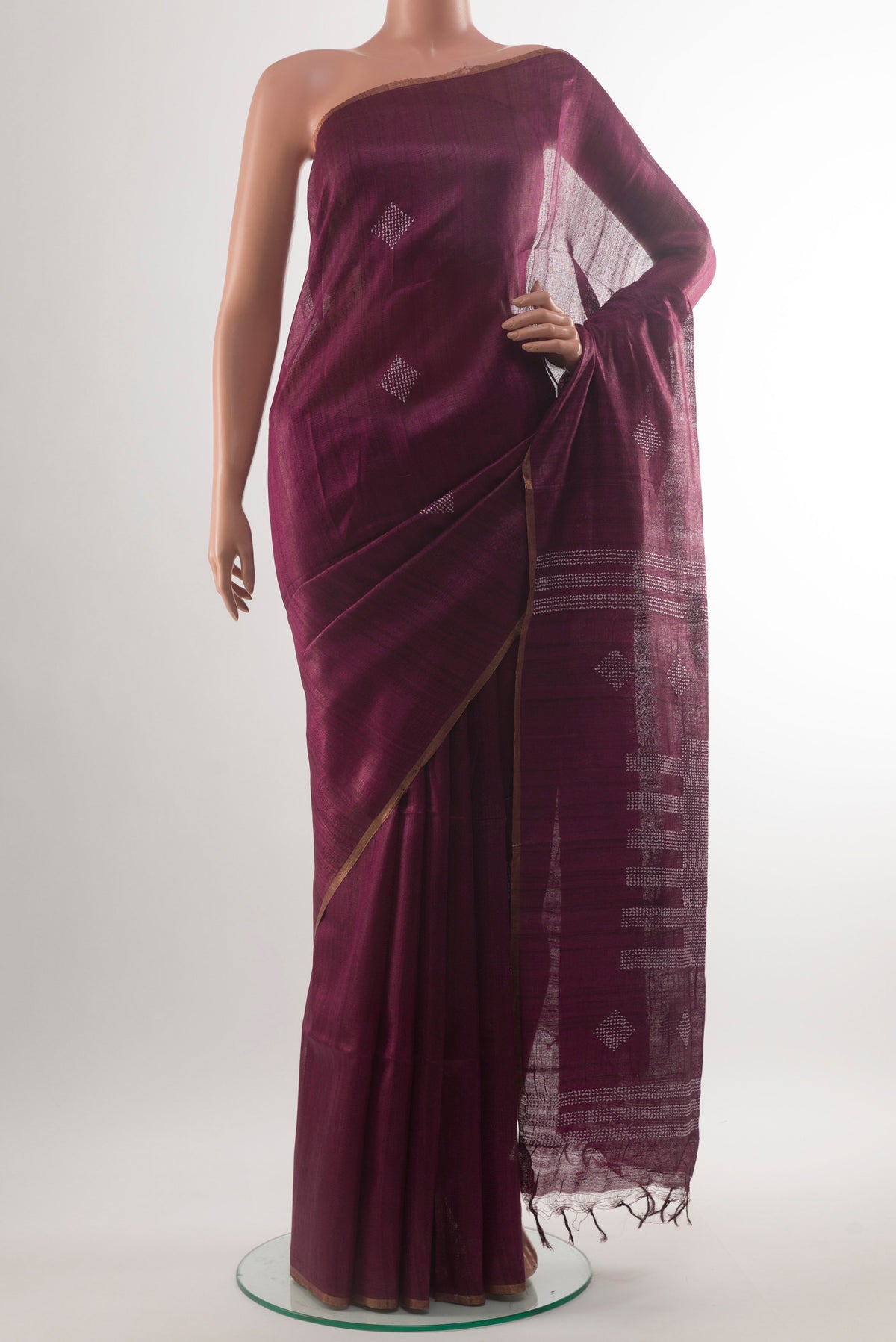 Burgundy Tussar Saree with Thread Butta on the body and Zari Border.  displayed on a mannequin