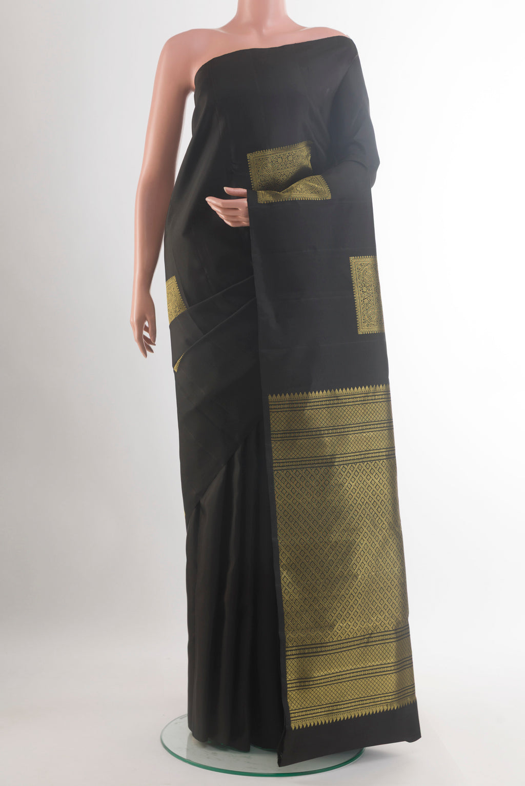 Pure Silk Black Kanchipuram Saree with Zari Butta on the body and Without Border.  displayed on a mannequin