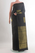 Pure Silk Black Kanchipuram Saree with Zari Butta on the body and Without Border.  displayed on a mannequin