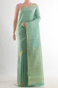 Pure Silk Mint Green Kanchipuram Saree with Zari Butta on the body and Zari Border.  displayed on a mannequin