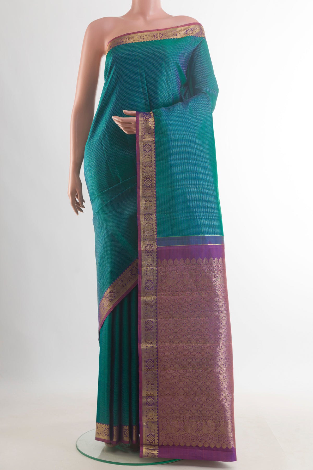 Pure Silk Peacock Blue Kanjivaram Saree with Zari Butta on the body and Zari Border.  displayed on a mannequin
