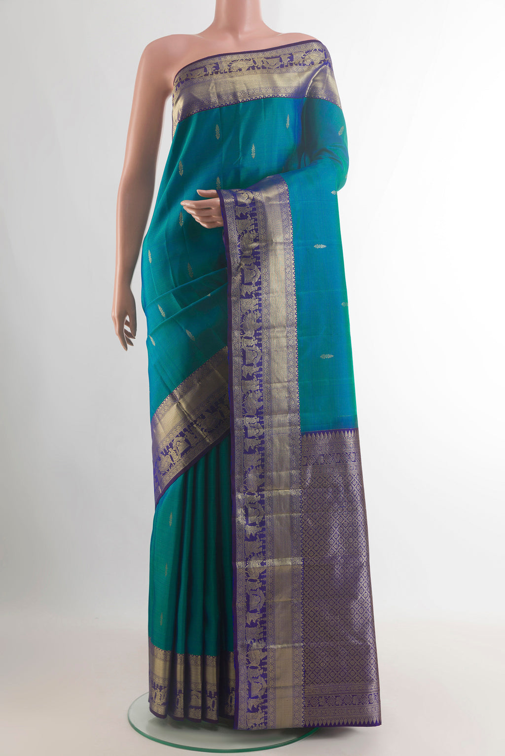 Pure Silk Sea Green Kanchipuram Saree with Zari Butta on the body and Zari Border.  displayed on a mannequin