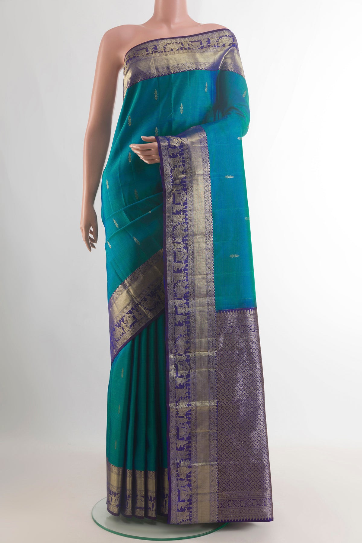 Pure Silk Sea Green Kanchipuram Saree with Zari Butta on the body and Zari Border.  displayed on a mannequin