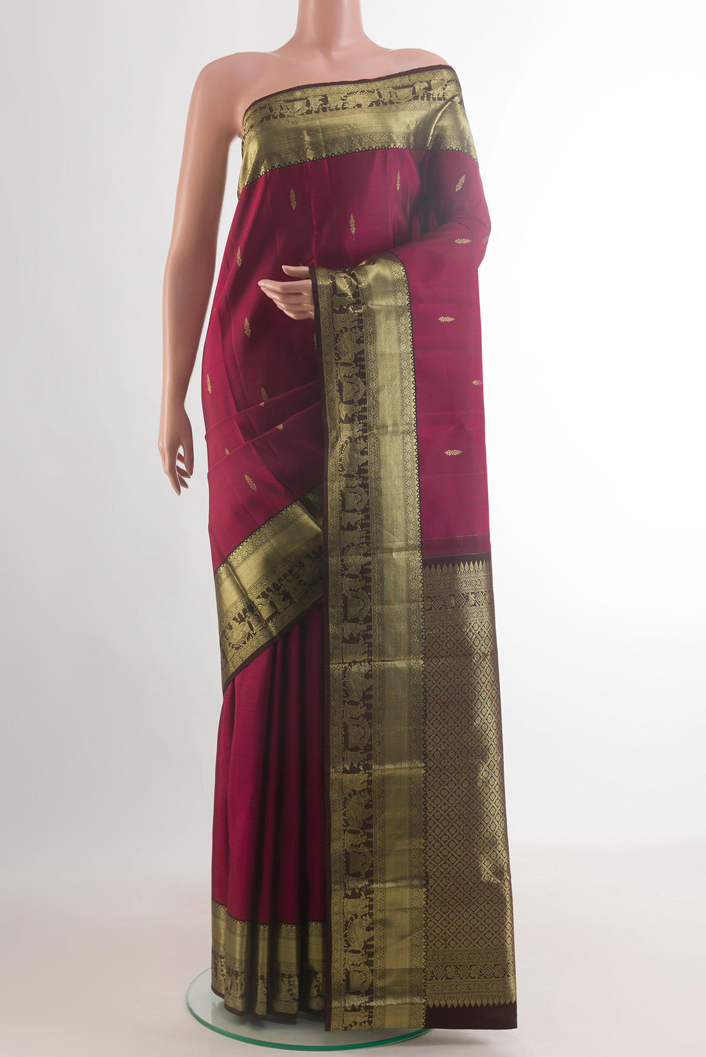 Pure Silk Maroon Kanchipuram Saree with Zari Butta on the body and Zari Border.  displayed on a mannequin