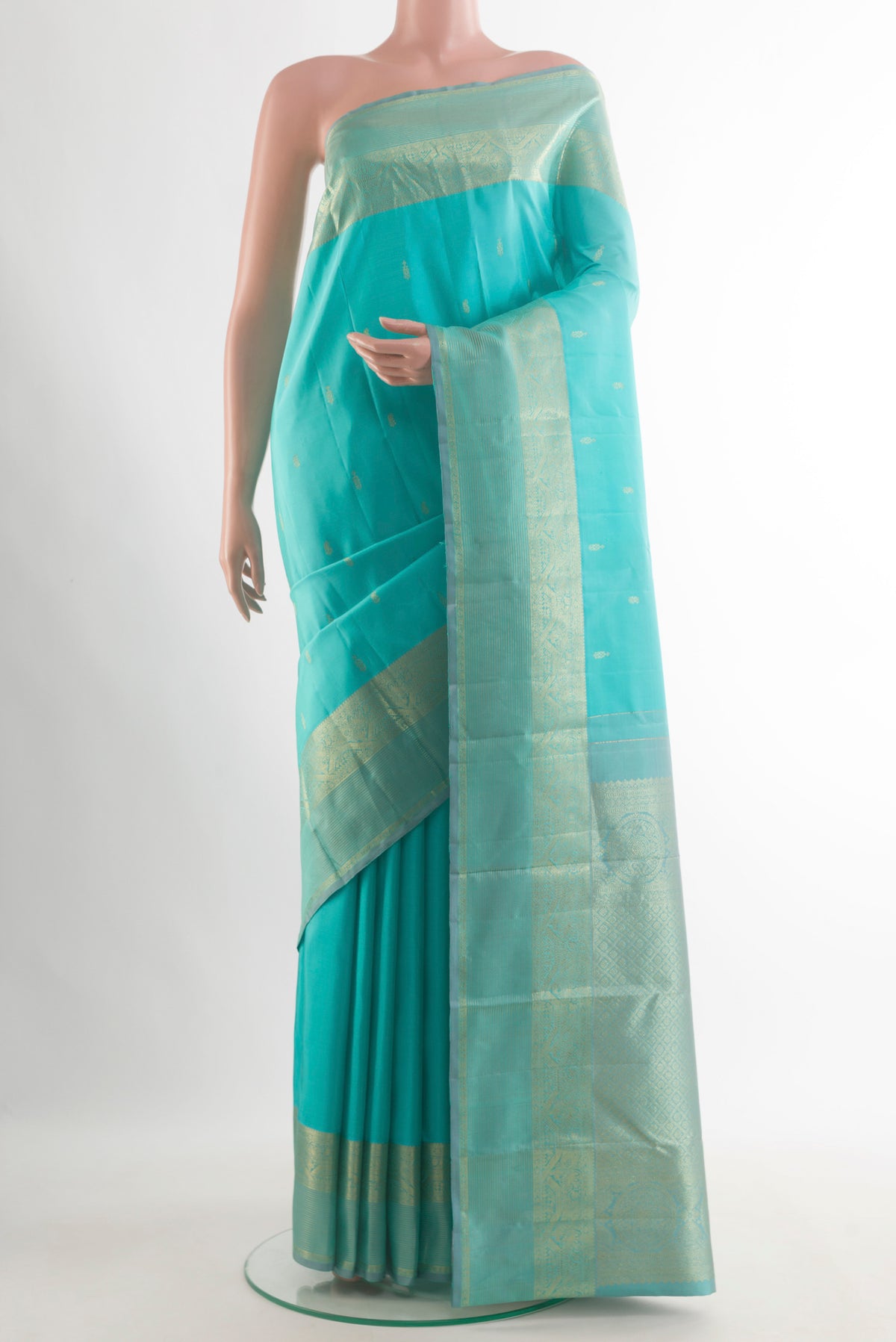 Pure Silk Turquoise Kanchipuram Saree with Zari Butta on the body and Zari Border.  displayed on a mannequin