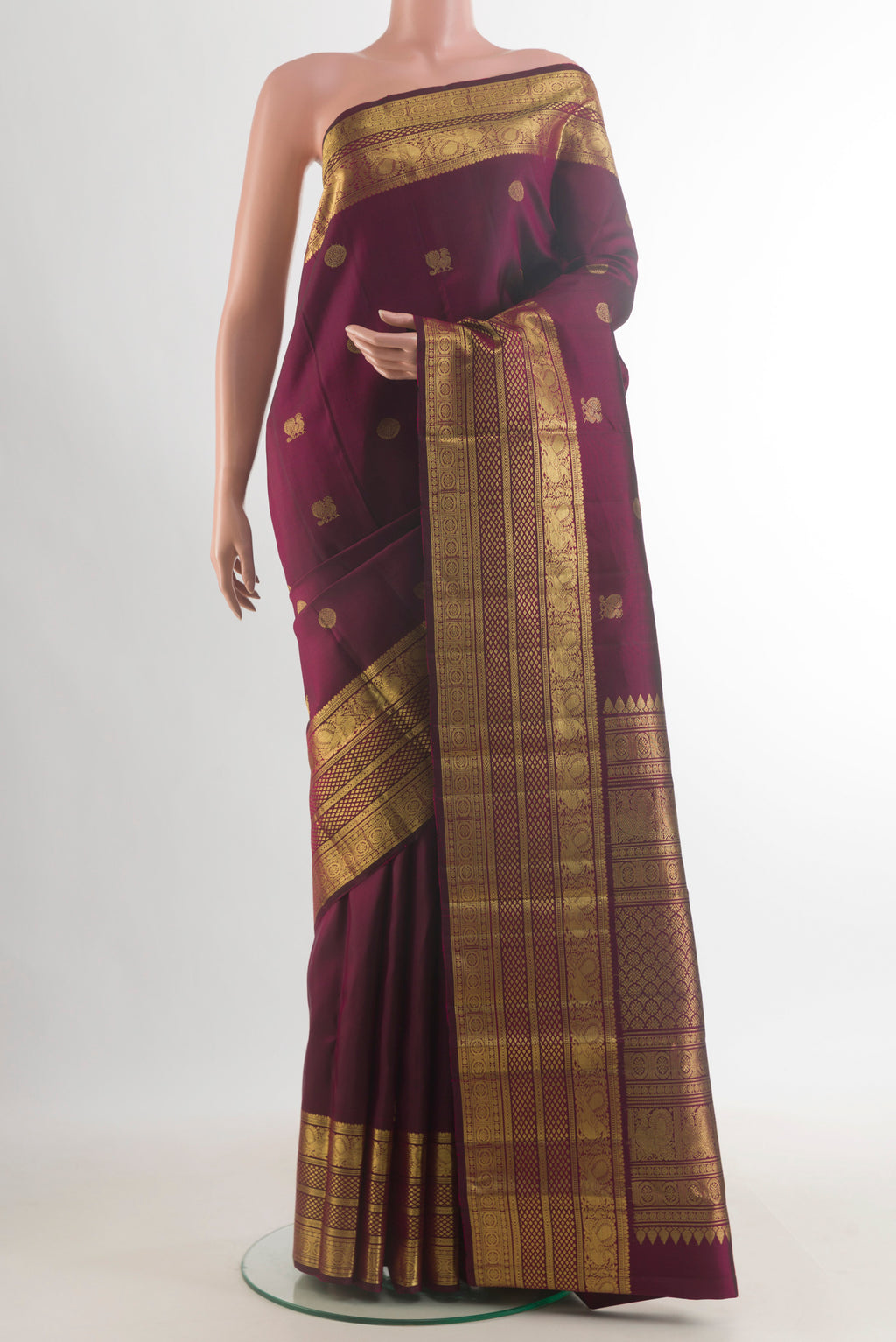 Pure Silk Coffee Brown Kanchipuram Saree with Zari Butta on the body and Zari Border.  displayed on a mannequin