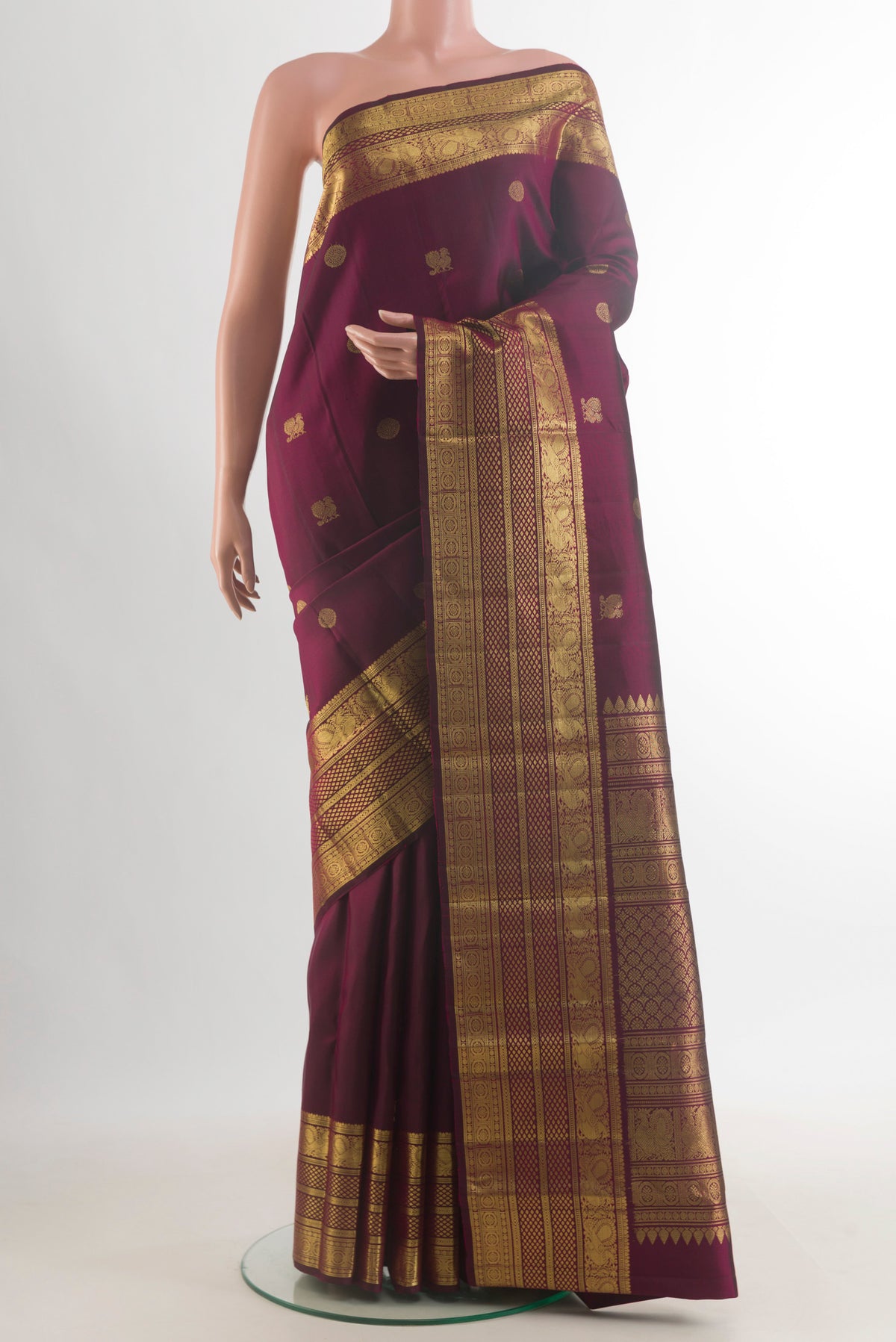 Pure Silk Coffee Brown Kanchipuram Saree with Zari Butta on the body and Zari Border.  displayed on a mannequin