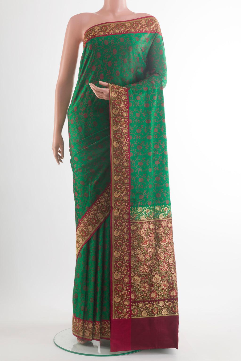 Green Banarasi Tanchoi Saree with Jacquard design on the body and Embroidery Border.  displayed on a mannequin