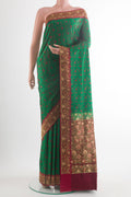 Green Banarasi Tanchoi Saree with Jacquard design on the body and Embroidery Border.  displayed on a mannequin