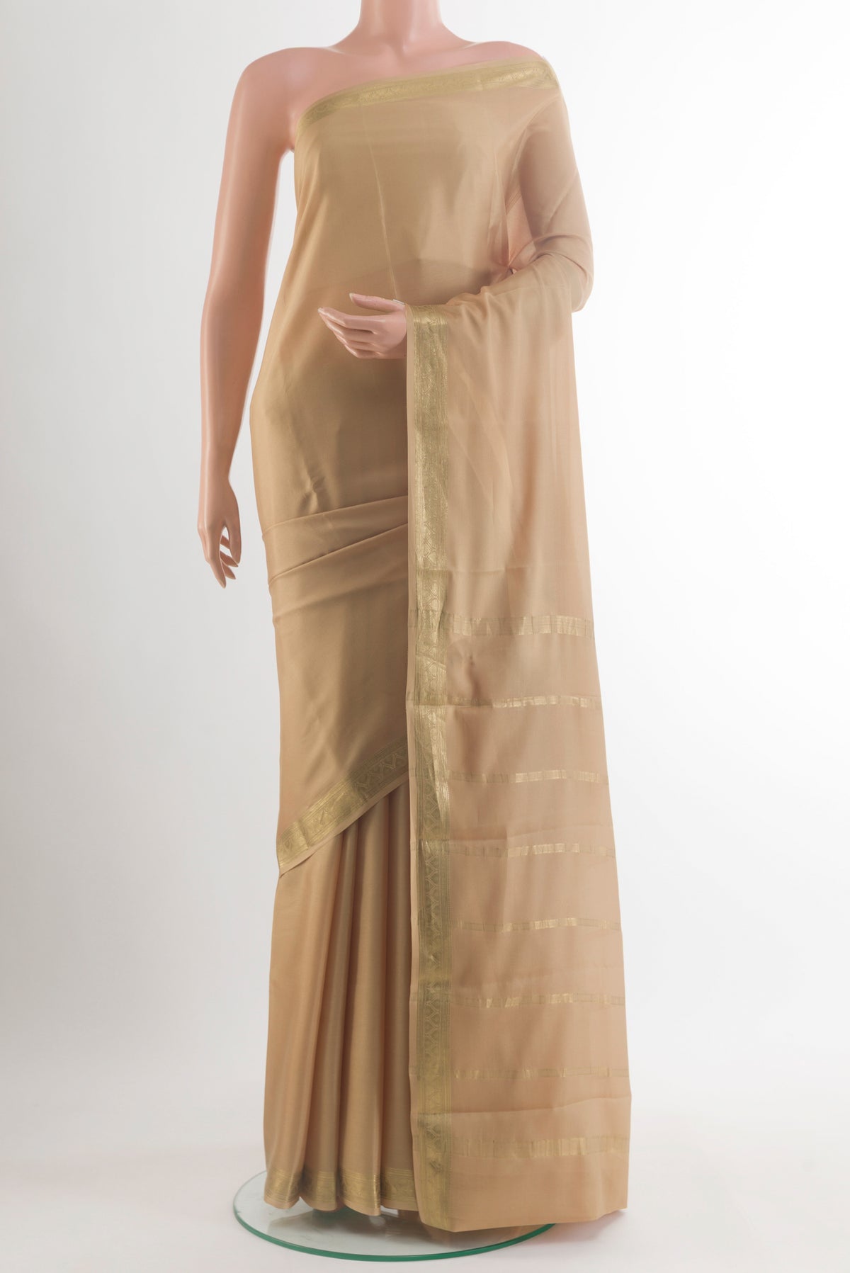 Beige Mysore Crepe Saree with Plain Body and Zari Border.  displayed on a mannequin