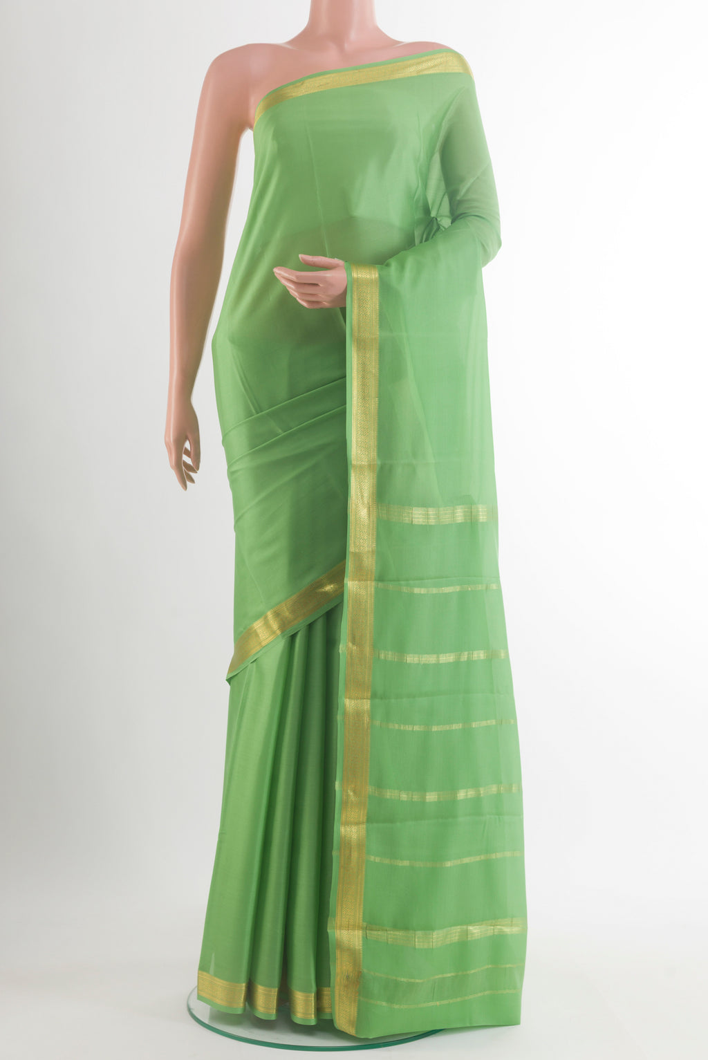 Green Mysore Crepe Saree with Plain Body and Zari Border.  displayed on a mannequin