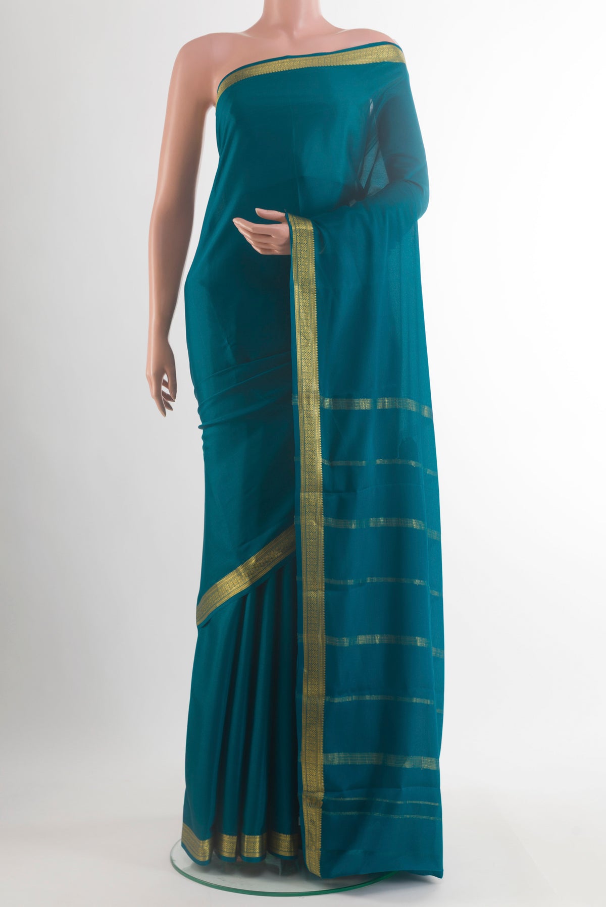 Teal Mysore Crepe Saree with Plain Body and Zari Border.  displayed on a mannequin