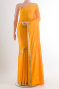 Yellow Mysore Crepe Saree with Plain Body and Zari Border.  displayed on a mannequin