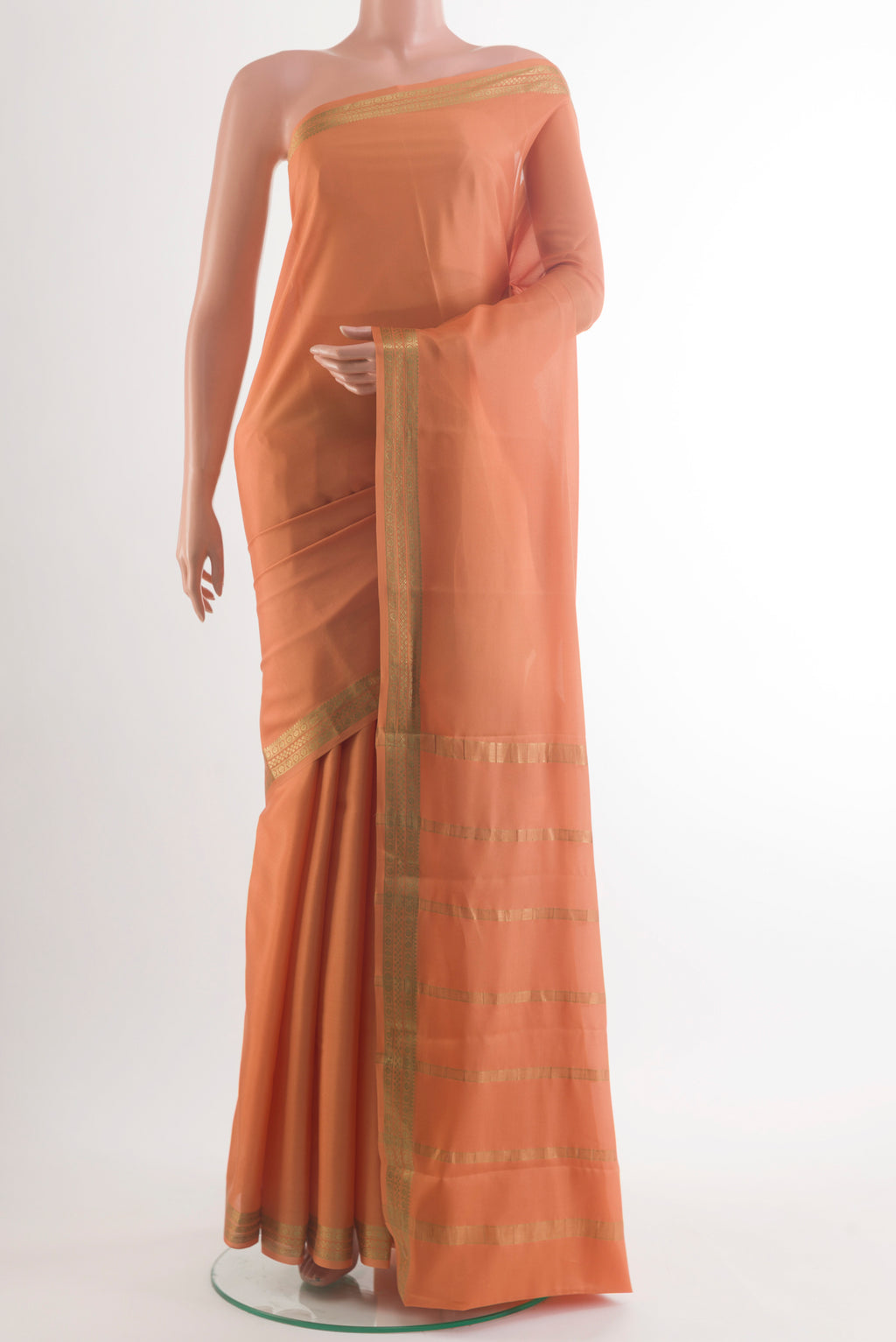 Peach Mysore Crepe Saree with Plain Body and Zari Border.  displayed on a mannequin