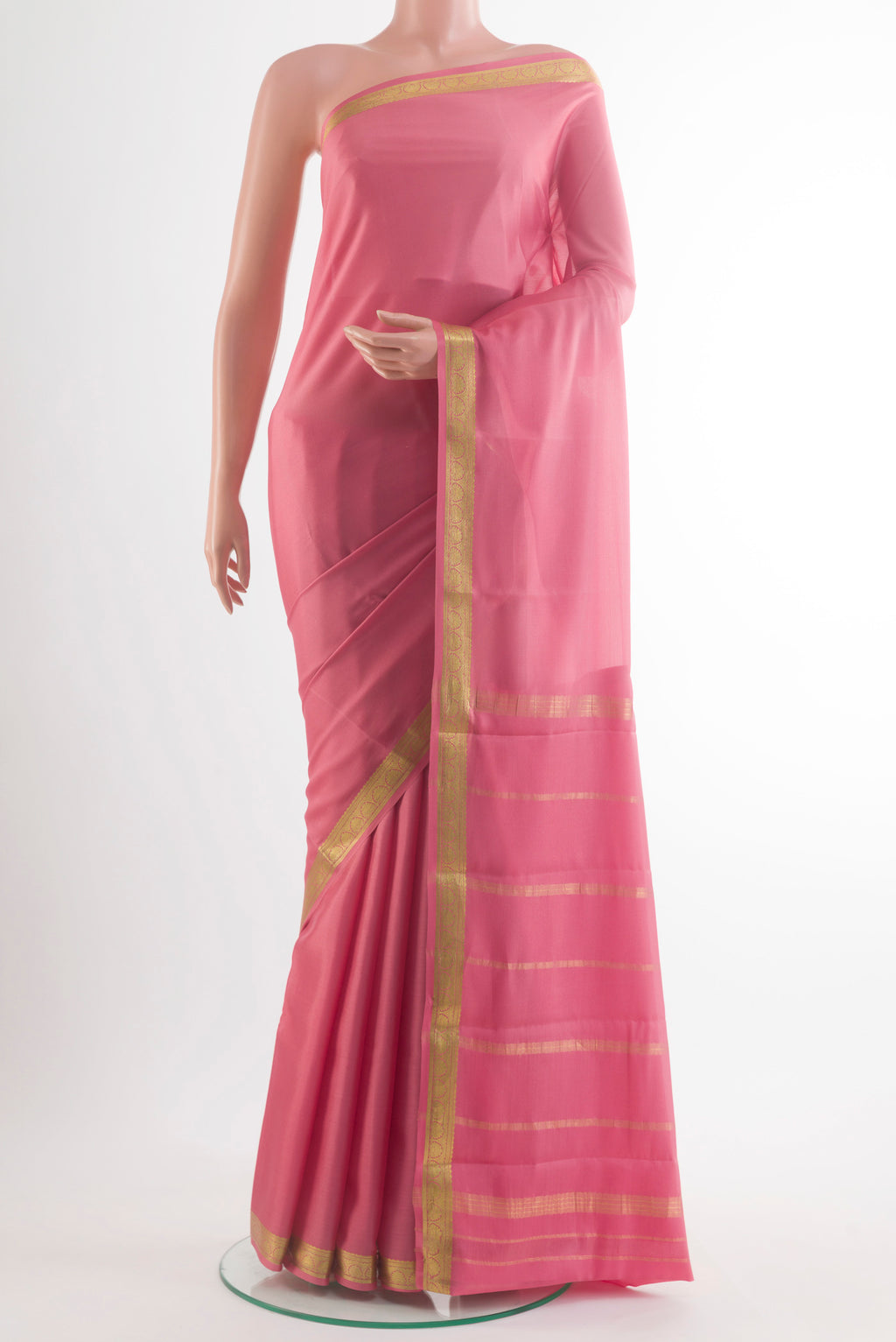 Peach Mysore Crepe Saree with Plain Body and Zari Border.  displayed on a mannequin
