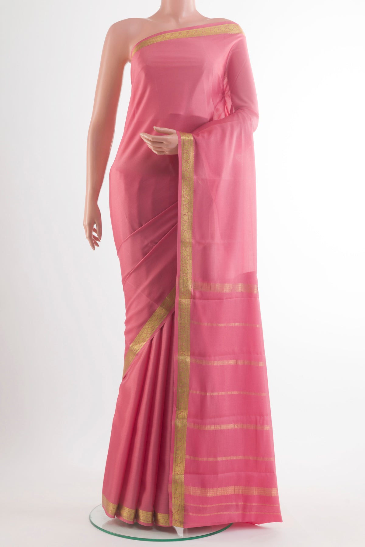 Peach Mysore Crepe Saree with Plain Body and Zari Border.  displayed on a mannequin