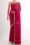 Red Mysore Crepe Saree with Plain Body and Zari Border.  displayed on a mannequin
