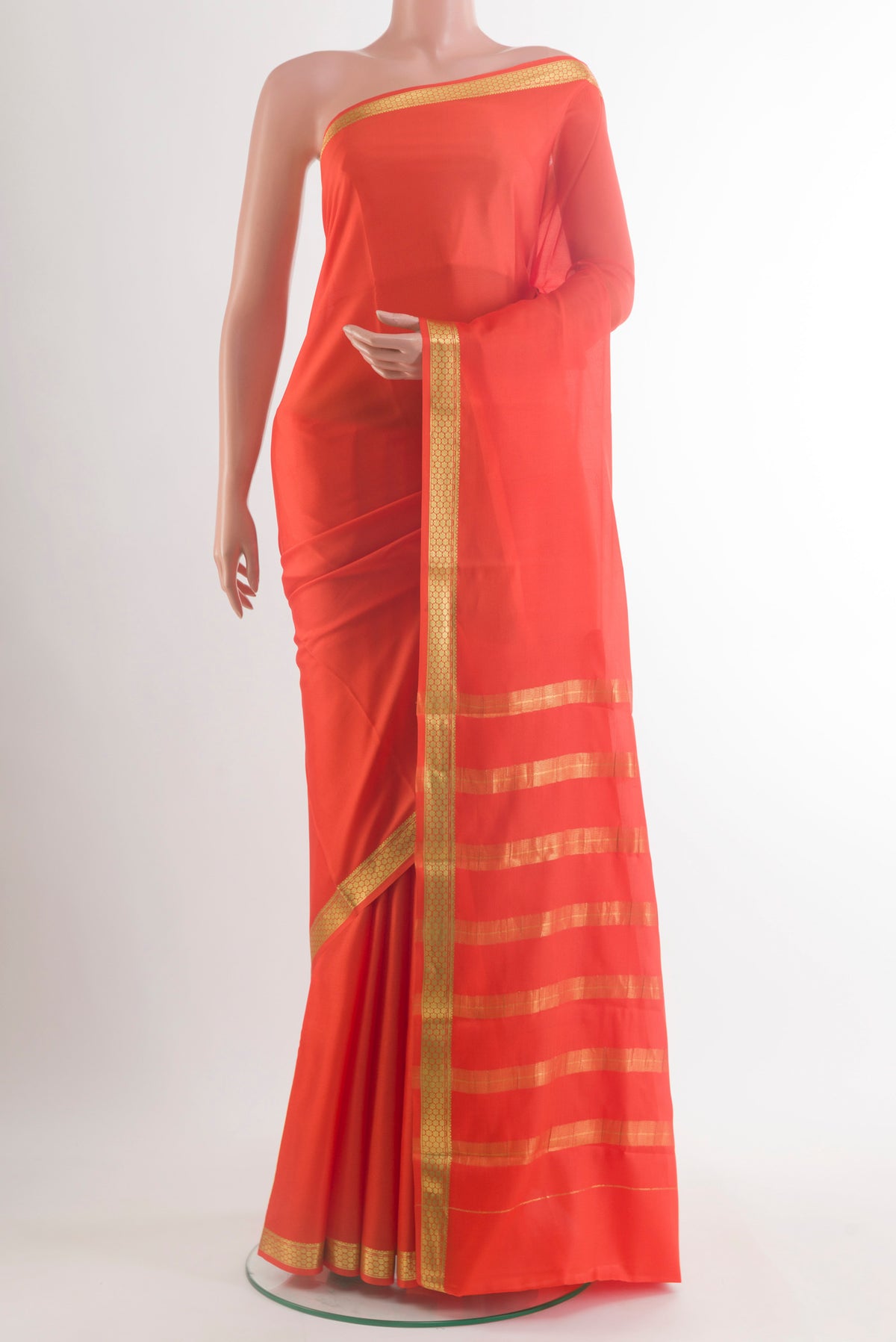 Orange Mysore Crepe Saree with Plain Body and Zari Border.  displayed on a mannequin
