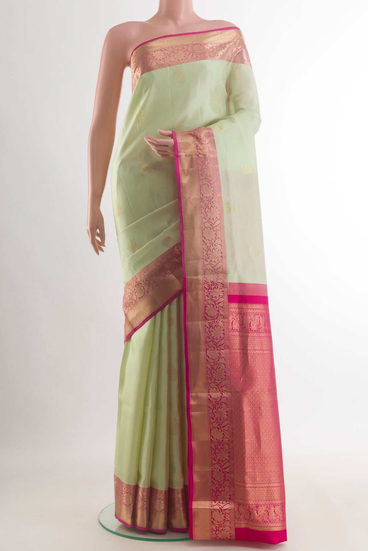 Pure Silk Cream Soft Saree with Zari Butta on the body and Zari Border.  displayed on a mannequin